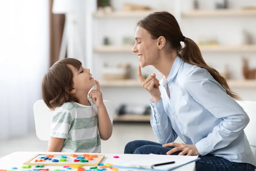 Child and adult practicing communication techniques together