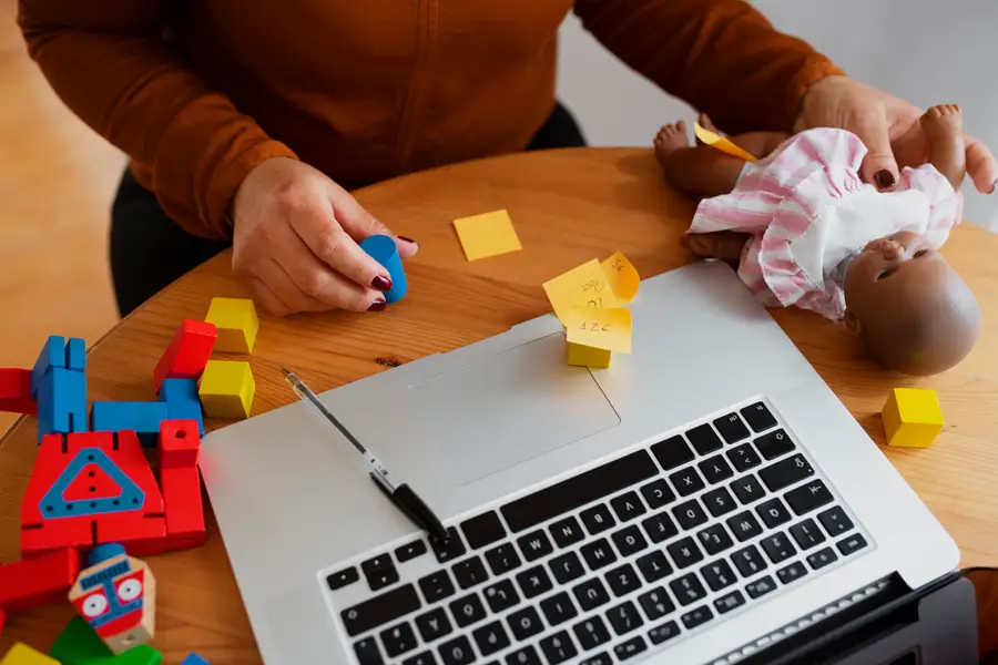 AAC session setup with toys, a laptop, and visual cues used for child communication support